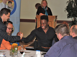 Eddie shaking hands at Rotary event